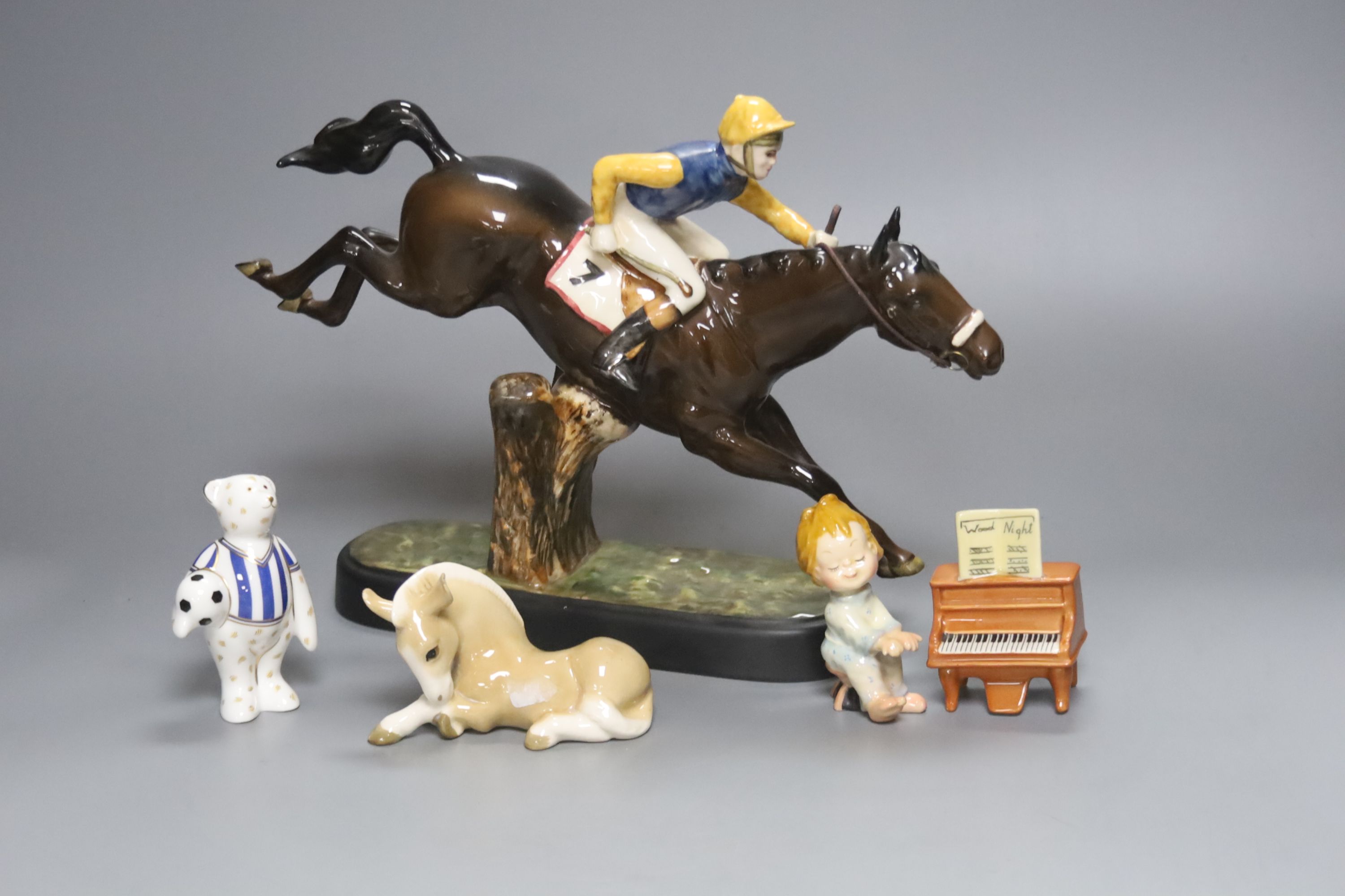 A Beswick racehorse and jockey, height 22cm, a Beswick child playing piano, a Royal Crown Derby bear footballer and a Continental earth